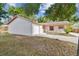 Brick house with a white garage door and a well-maintained lawn at 503 Avocado Cir, Brandon, FL 33510
