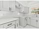 Renovated kitchen, featuring gray cabinets and white quartz countertops at 503 Avocado Cir, Brandon, FL 33510