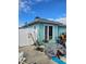 Side of a light blue home with a sliding glass door leading to the backyard at 610 78Th Ave, St Pete Beach, FL 33706