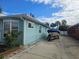 Side of teal house with boat and trailer in driveway at 610 78Th Ave, St Pete Beach, FL 33706