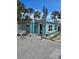 Charming teal bungalow with a spacious yard and tropical landscaping at 610 78Th Ave, St Pete Beach, FL 33706