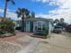 Light teal house with palm trees and boat in driveway at 610 78Th Ave, St Pete Beach, FL 33706