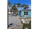 Side view of teal home showing landscaping and driveway at 610 78Th Ave, St Pete Beach, FL 33706