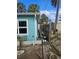 Side view of the light blue home with a white framed window at 610 78Th Ave, St Pete Beach, FL 33706