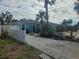 Charming single-story home with a gravel driveway and lush tropical landscaping at 610 78Th Ave, St Pete Beach, FL 33706