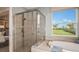 Bathroom with large shower, soaking tub, and view to backyard at 721 Sky Shade Dr, Apollo Beach, FL 33572