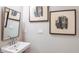 Small bathroom with pedestal sink and framed art at 721 Sky Shade Dr, Apollo Beach, FL 33572