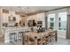 Island kitchen with white cabinets, stainless steel appliances, and a wooden dining table at 721 Sky Shade Dr, Apollo Beach, FL 33572