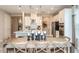 Island kitchen with white cabinets, stainless steel appliances, and a wooden dining table at 721 Sky Shade Dr, Apollo Beach, FL 33572