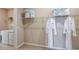 Laundry room with washer, dryer, and ample shelving at 721 Sky Shade Dr, Apollo Beach, FL 33572