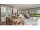 Open living and dining area with a large sectional sofa and sliding glass doors at 721 Sky Shade Dr, Apollo Beach, FL 33572