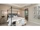 Main bedroom with a four poster bed, neutral decor and plenty of natural light at 721 Sky Shade Dr, Apollo Beach, FL 33572