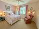 Charming bedroom with a relaxing sitting area and a view at 1003 Pussywillow Ln, Bradenton, FL 34208