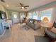 Living room with gray sofa and rocking chair, view to backyard at 1003 Pussywillow Ln, Bradenton, FL 34208