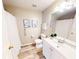Clean bathroom featuring a white vanity, toilet, shower with curtain, and wood-look floors at 10543 Opus Dr, Riverview, FL 33579