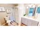 Well-lit bathroom featuring a glass door shower, modern vanity and stylish decor at 10543 Opus Dr, Riverview, FL 33579