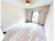 Empty bedroom with wood floors and a large window, perfect for customization at 10543 Opus Dr, Riverview, FL 33579