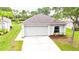 Charming single-story home with a well-maintained lawn and attached two-car garage at 10543 Opus Dr, Riverview, FL 33579