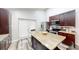 Modern kitchen with stainless steel appliances, wooden island, and lots of counter space at 10543 Opus Dr, Riverview, FL 33579