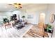 Spacious living room featuring wood floors, modern furniture, and ample natural light at 10543 Opus Dr, Riverview, FL 33579
