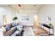 Bright living room with wood floors, a comfortable gray sofa, and modern décor at 10543 Opus Dr, Riverview, FL 33579