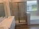 Bathroom featuring a large shower, a soaking tub, tile accents, and double sink vanity at 16026 10Th E Ave, Bradenton, FL 34212