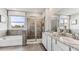 Modern bathroom featuring a walk-in shower, soaking tub, and granite countertops at 16026 10Th E Ave, Bradenton, FL 34212