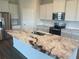 Kitchen island featuring granite countertops, a stainless steel sink, and modern fixtures at 16026 10Th E Ave, Bradenton, FL 34212