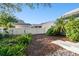 Small backyard with mulch, plants, and a fence at 1903 Gulf Beach Blvd, Tarpon Springs, FL 34689