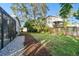Landscaped backyard with gravel pathway and privacy fence at 1903 Gulf Beach Blvd, Tarpon Springs, FL 34689