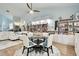 Elegant dining area featuring a glass table and modern chairs, adjacent to a well-stocked bookshelf at 1903 Gulf Beach Blvd, Tarpon Springs, FL 34689