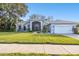 Single-story home with a landscaped lawn and attached garage at 1903 Gulf Beach Blvd, Tarpon Springs, FL 34689