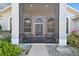 Screened porch with seating area at the front entrance at 1903 Gulf Beach Blvd, Tarpon Springs, FL 34689