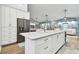 Spacious kitchen with island, stainless steel appliances, and white cabinetry at 1903 Gulf Beach Blvd, Tarpon Springs, FL 34689