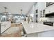 Open concept kitchen with large island, white cabinetry and granite countertops at 1903 Gulf Beach Blvd, Tarpon Springs, FL 34689