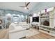 Relaxing living room with a white couch, ceiling fan and built-in shelving at 1903 Gulf Beach Blvd, Tarpon Springs, FL 34689