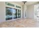 Covered patio with travertine tile flooring and sliding glass doors at 19893 Sambar Deer Loop, Lutz, FL 33559