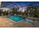 Enclosed pool and spa with waterfall features at sunset at 19893 Sambar Deer Loop, Lutz, FL 33559