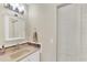 Bright bathroom featuring a white vanity, decorative tile accents, and a linen closet at 210 Sun Vista N Ct # 61, Treasure Island, FL 33706