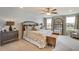 Large main bedroom with king-size bed, bench, and large mirror at 3530 Thistle Bank Ct, Plant City, FL 33565