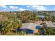 Aerial view showcasing a charming house with a gray roof and light blue exterior at 3863 Belle Vista E Dr, St Pete Beach, FL 33706