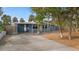 Light blue home with carport, landscaped yard, and mature trees at 3863 Belle Vista E Dr, St Pete Beach, FL 33706