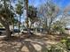 Front view of a light blue house with a gravel driveway at 3863 Belle Vista E Dr, St Pete Beach, FL 33706