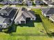 Beautiful aerial view of a home with a spacious, fenced backyard and a screened-in patio, perfect for relaxing outdoors at 3901 Tour Trce, Land O Lakes, FL 34638