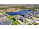 An aerial view showing homes, a nearby lake, and manicured lawns at 3901 Tour Trce, Land O Lakes, FL 34638