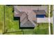 Striking aerial view showcasing the home's unique roof design, complemented by well-manicured landscaping and lush green lawns at 3901 Tour Trce, Land O Lakes, FL 34638