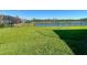 Lush backyard with black metal fencing and a tranquil lake view at 3901 Tour Trce, Land O Lakes, FL 34638