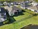 Aerial shot of backyard featuring green grass, fence and view of pond at 3901 Tour Trce, Land O Lakes, FL 34638