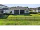 Expansive backyard features lush green grass and secure black metal fencing at 3901 Tour Trce, Land O Lakes, FL 34638