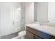 Bathroom with glass-enclosed shower, granite vanity, and pebble tile floor at 3901 Tour Trce, Land O Lakes, FL 34638